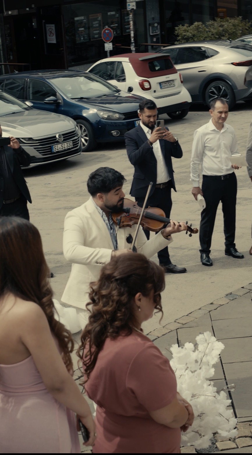 Gabriel performing violin for guests